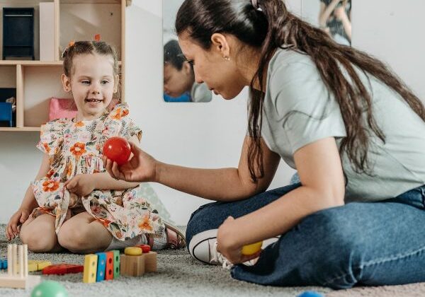 teacher handing a ball to a student
