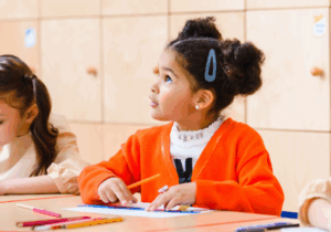 little girl sitting at desk